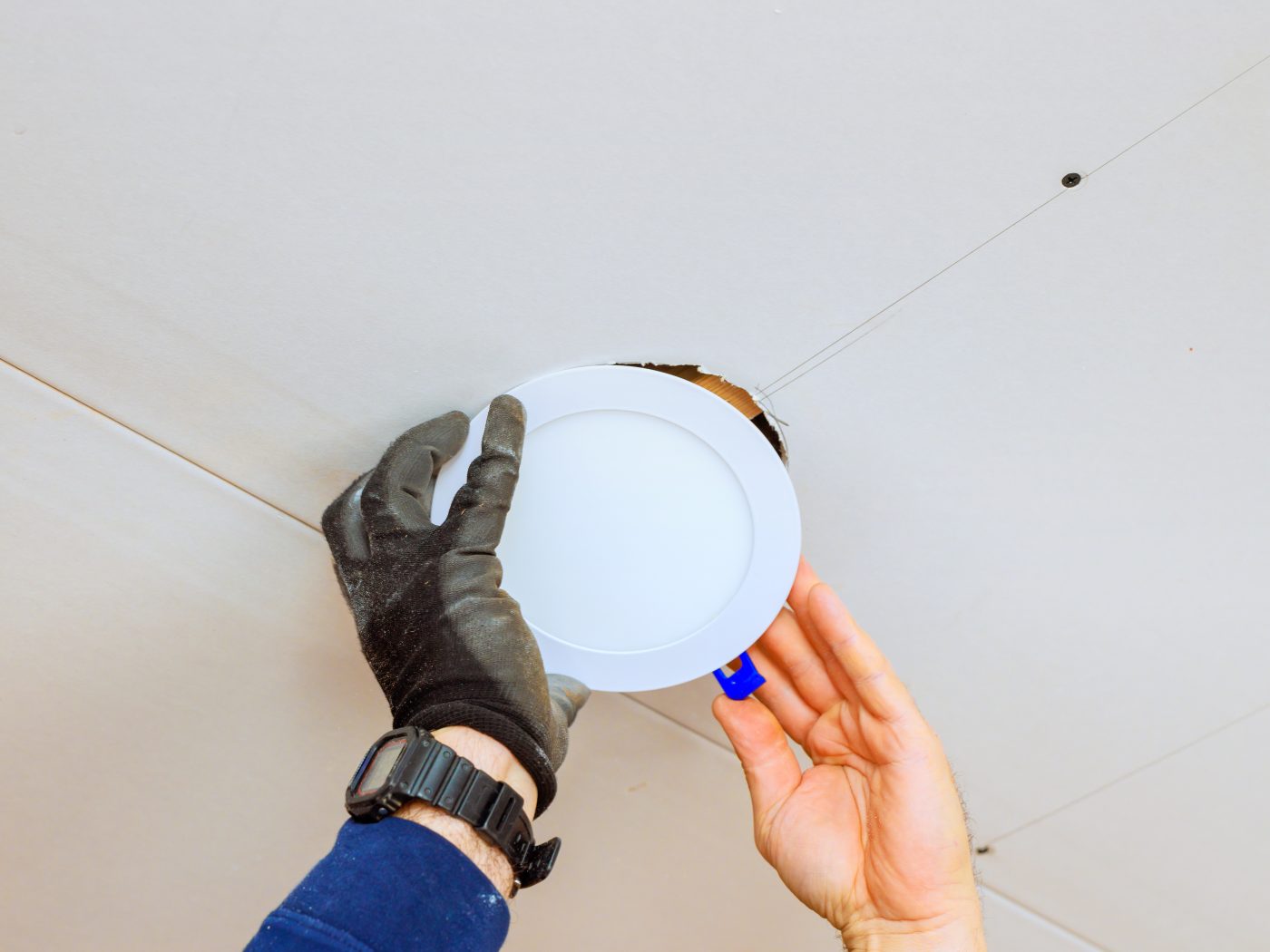 Installing a canless LED recessed downlight in a ceiling, representative of lighting installation and LED upgrades.